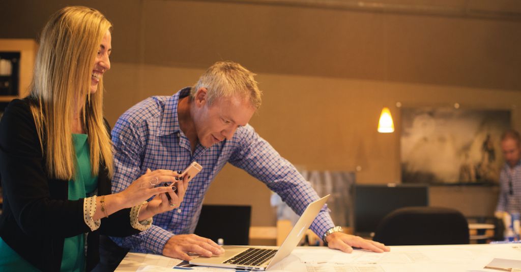 Two people looking at laptop screen