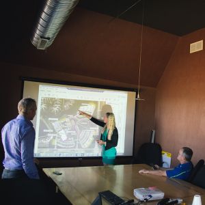 Perficut Team Member Giving A Presentation in the office using a projector