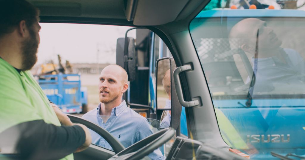 Man talking to driver of truck