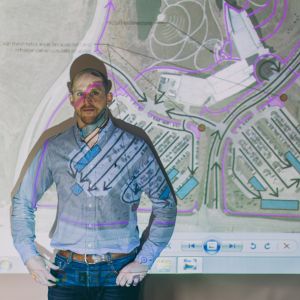 Kyle standing in front of projector with a map displayed