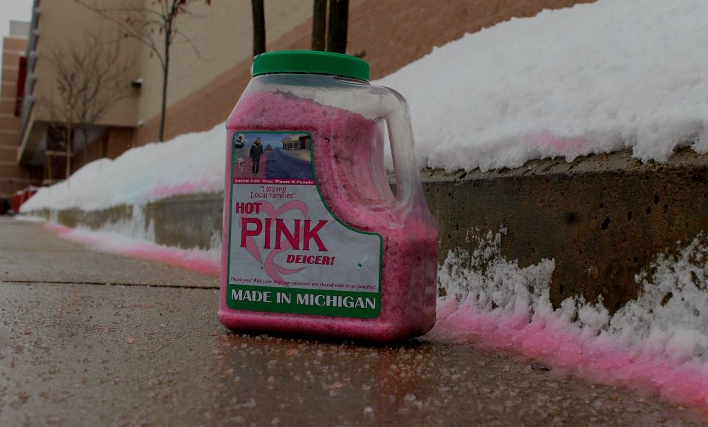 A bottle of Hot Pink Deicer on a sidewalk