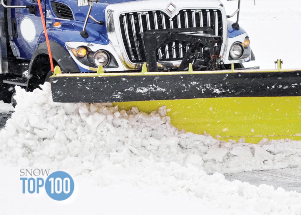 Snow plow plowing street