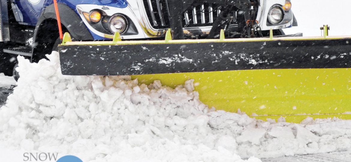 Snow plow plowing street
