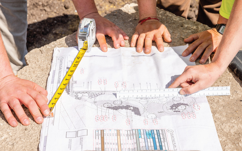 close up of a group of people reviewing landscaping plans