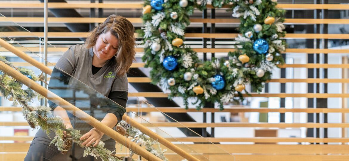 Perficut team member putting up holiday decor